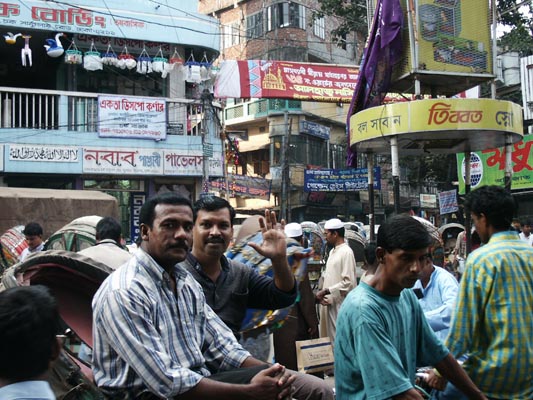 Mr. Safapei waves from a rickshaw