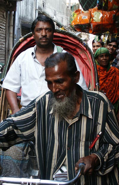 Rickshaw wallah with customer, Dhaka