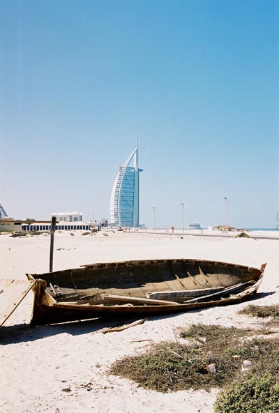 An old boat on the beach near the Burj