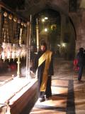 Holy Person marching around church with incense past the Stone of the Unction