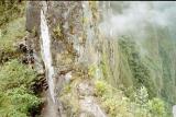 Steep drop-off on both sides; trail on the left, river on the right