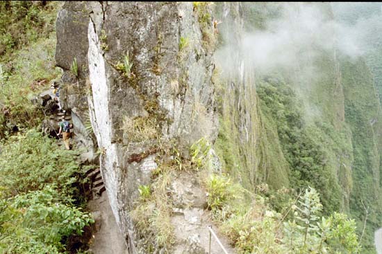 Steep drop-off on both sides; trail on the left, river on the right