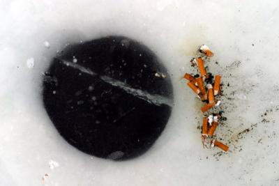Some fishermen are not very environmentally sensitive.  This one left a pile of cigarette butts next to his hole.