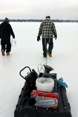 Fishermen tow their portable ice houses to a fishing spot. The floor of the ice house acts as a sled.