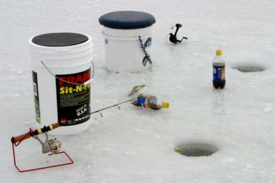 The owners of this equipment didn't have an ice house. They sit on their bait buckets while they fish.