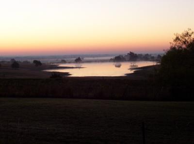 This is a small lake that is my favorite place to see sunrises from during my commute.  However, this view is deceiving from the angle I generally see this lake at.  The road I'm always on seems almost ground-level to the water.  I took a smaller road that's elevated but without traffic so I could pull over and capture this sunrise.  My normal road goes down a hill, curves, then back up a hill (with no place to pull over).  This particular morning I couldn't pass up the sunrise over my lake so I took an off-shoot smaller road that's higher elevation and not on a curve, allowing a way to very briefly pull over and snap this photo.  It's hard to see beauty like this and not believe that God is the greatest artist of all.