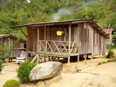 Wooden house with satellite dish & carport