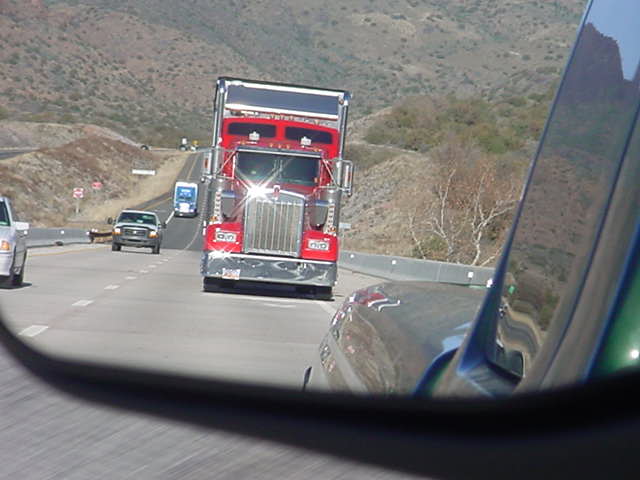 red big rig trucker<br>in the rearview mirror
