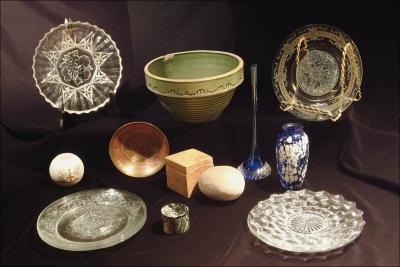 13. a variety of small clear glass plates, a crockery bowl, and assorted other objects