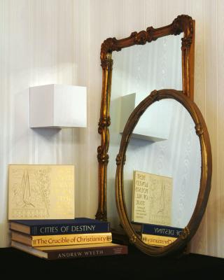 26. four coffee table books & two mirrors with gold frames, one 26 in diameter & the other 27.5 x 37