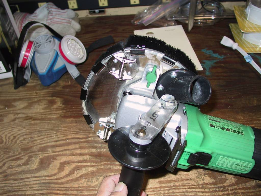 Handle, vacuum inlet.  Green thumb screw adjusts cutting depth. Notice the respirator in the background too!