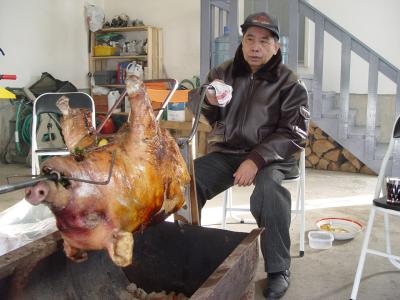 Dr. Louie Magtibay roasting the front part of the pig.