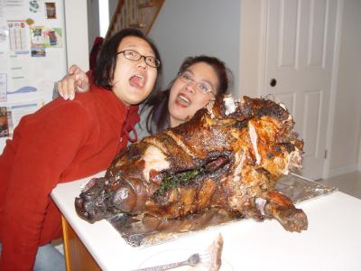 Caroline and Gina trying to swallow the pig.