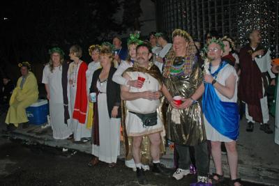 The Toga Krewe attends the Bacchus Parade