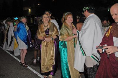 The Toga Krewe attends the Bacchus Parade