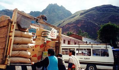 Pisac Market: unloading with gorgeous hill formations behind
