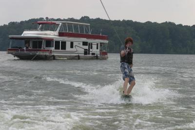 Shawn wakeboarding by the houseboat