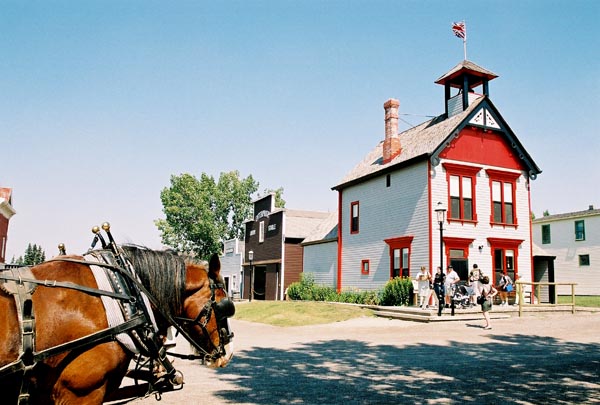 A horse-drawn carriage approaching the old Calgary Town Hall