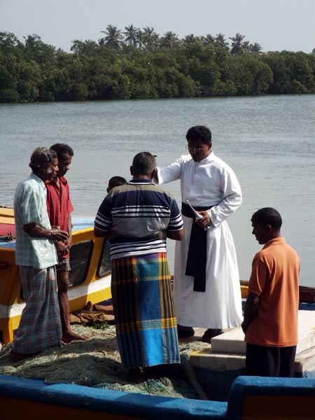 Catholic priest blessing the crew