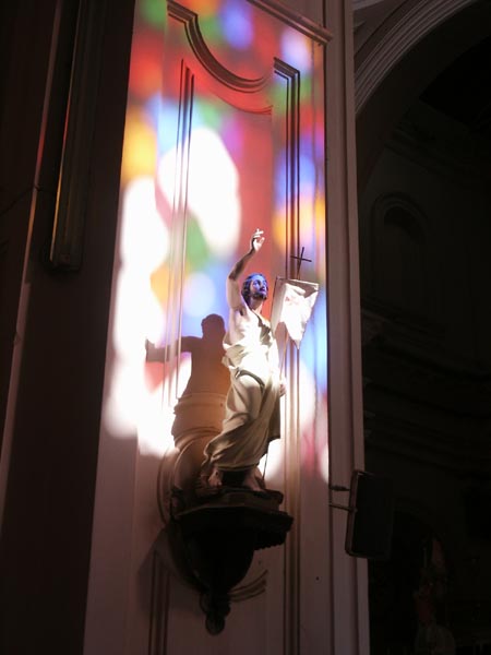 Light shining on Jesus through the stained glass windows