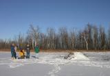Group out on the frozen wetland near an active beaver lodge