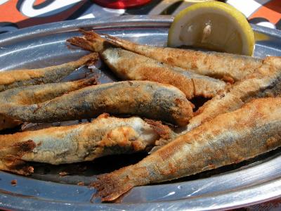 Freshly caught sardines straight off the boat, dipped in olive oil, flour, and pan fried.  Pure Heaven.