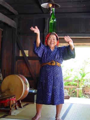 Lady dancing with awamori on her head
