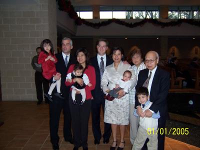 Tricia's family (Isabel, Michael, Caroline, Sophia, Lola, Lolo, and little Michael) join John, Tricia, and Evan for Evan's baptism at St. Thomas More Church in Chapel Hill, NC