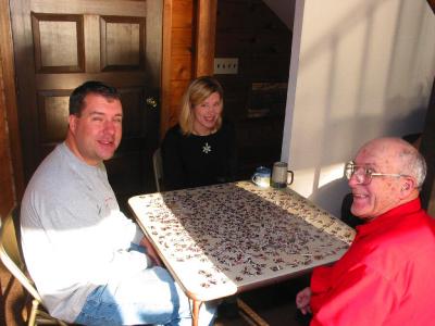 Greg Rachel and Grandpa working the puzzle
