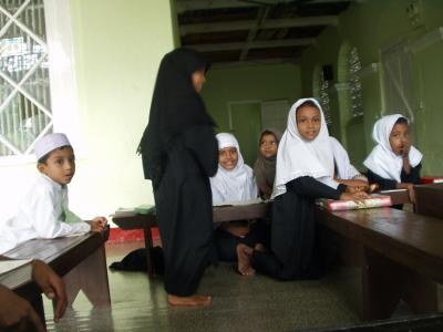 Boys and girls together, reading the Quran
