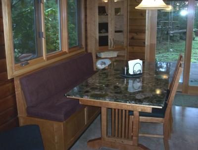 Verde Marinace tabletop with Vermont Furniture cherry tablebase and chairs. Bench seat built by cabinetmaker (Integrity Cabinets). Cushions are done in a dark purple microfibre (Durapella).