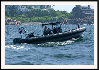 Secret Service inflatable fast boat trailing the fishing boat of former US President George Bush. Notice the agent in the back of the craft in scuba gear, ready to enter the water if need be. Poor quality due to very rough seas and very long lens (400mm).