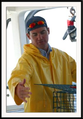 The (very young) captain of the tour boat, demonstrating lobstering techniques to the passengers.