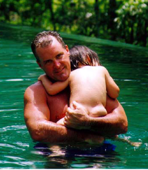 Mia and Daddy in the pool on daddys shoulder1.jpg