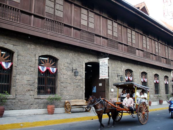 Tourist coach in front of Silahi's Emporium of Philippine Crafts, General Luna St., Intramuros