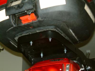 This shows the Givi E128 Base on the JR Rear Rack. Notice the E128 place hangs off the rear and the sides, but it is solidly bolted on the rack