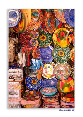 From the market along Cinco de Mayo near the beach.  
A chaotic riot of color and wares to tempt you.  
Deep inside the ramshackle shops there were lots of lacquerware, 
silverwork and other crafts but it was hard to linger because it was
so stiflingly hot with no cross ventilation.
