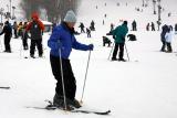 The instructor told Beverly that crossing her skis for good luck will help her ski better.