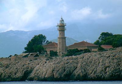 Lighthouse with mountain backdrop