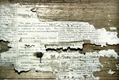 Old newspaper on wall of derelict house