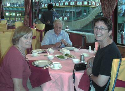 Three Australian tourists at a restaurant on a dragon boat