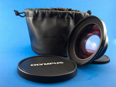WCON-08B is a wide angle attachment lens for the Olympus Cameras. When fitted to the front of the built-in lens, it will reduce its focal length by a factor of 0.8, this is equivalent to 28 mm on a 35-mm film camera. The front end is threaded and accepts 105-mm screw-on filters and the camera end is 62mm. The lens sell for around $130. 
For more on the lens visit Wronniak.Net   http://www.wrotniak.net/photo/e10/wcon-08b.html
