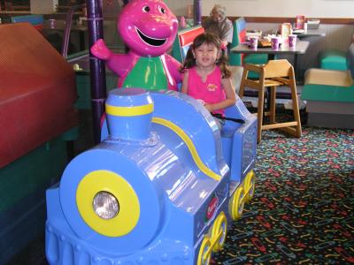 Sarah on Barney ride at Chuck E. Cheese's