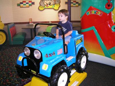 Kyle riding the 4X4 at  Chuck E. Cheese's