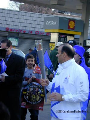 NY Yankee manager Joe Torre talks to the press and fans with the Olympic Torch