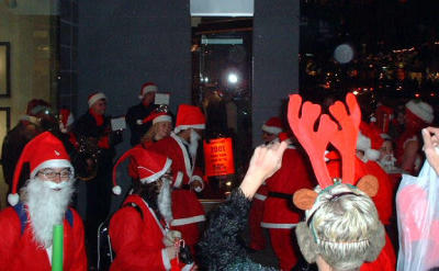Santa dancing to the music of street performers