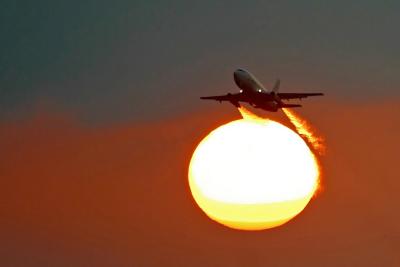 European Air Charter flies in front of the sun.