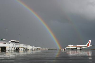 Air Portugal A319 receives a glorious rainbow.