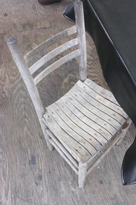 One of the old chairs; the ones that had nails that stuck out and ripped your pants.