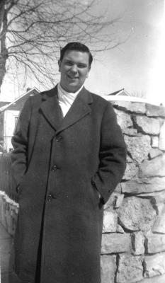 Bob in 1945 by Wall of Driveway at Parents' Home